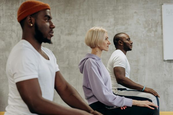 A diverse group of people of different ages practicing yoga together.